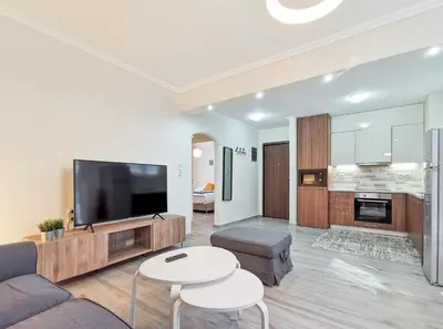 a living room with a couch and a tv at Charming 2BD apt next to metro station in Athens