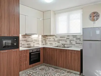 a kitchen with white appliances and wooden cabinets at Charming 2BD apt next to metro station in Athens