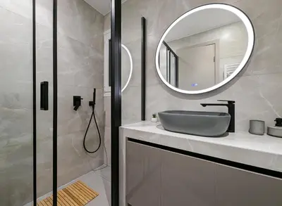 a bathroom with a sink and a mirror at Acropolis view 3BD penthouse next to tram and port in Piraeus