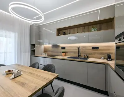 a kitchen with a wooden table and a dining room at Acropolis view 3BD penthouse next to tram and port in Piraeus