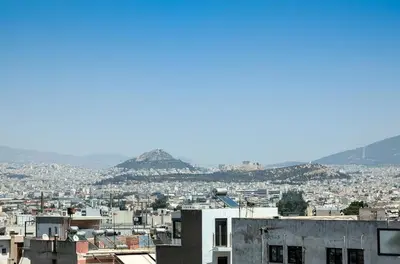 a view of a city with mountains in the background at Acropolis view 3BD penthouse next to tram and port in Piraeus