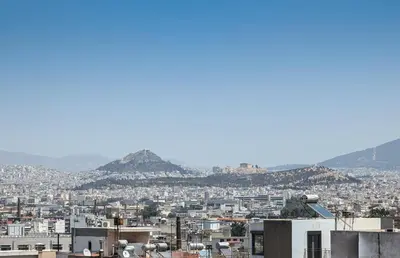 a view of a city with mountains in the background at Acropolis view 2BD penthouse next to tram and port in Piraeus