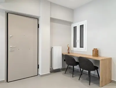 a dining room with a table and two chairs at Acropolis view 2BD penthouse next to tram and port in Piraeus