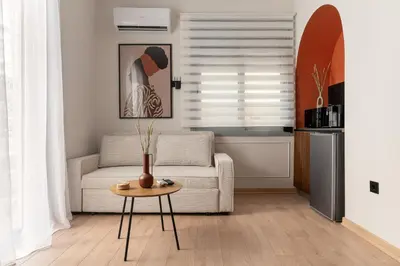a living room with a couch and a table at Phalerus Suites in Athens