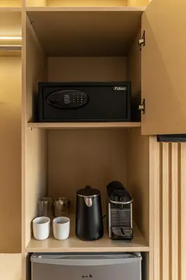 a microwave oven sitting on top of a shelf in a kitchen at Phalerus Suites in Athens