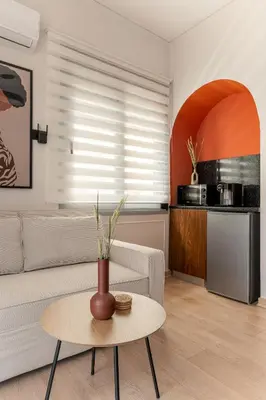 a living room with a couch and a table at Phalerus Suites in Athens