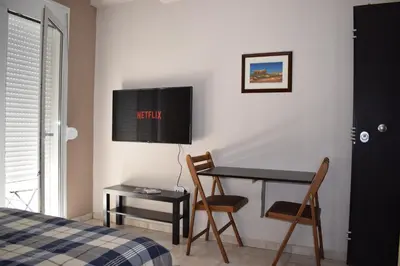 a bedroom with a desk and a table and chairs at Renovated City Center Studio in Athens