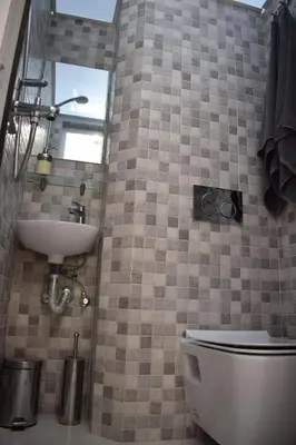 a bathroom with a toilet and a sink at Renovated City Center Studio in Athens