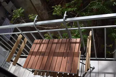 a wooden chair sitting on top of a railing at Renovated City Center Studio in Athens
