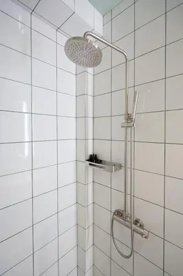 a shower with a shower head in a bathroom at Lofos Lumina Suites in Athens