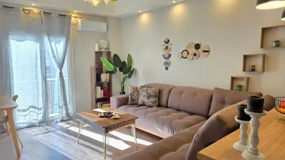 a living room with a couch and a table at Glory Appartment pippinou in Athens