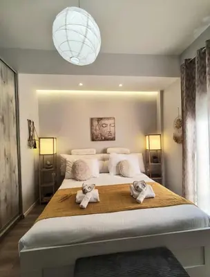 a bedroom with a large bed with towels on it at Glory Appartment pippinou in Athens