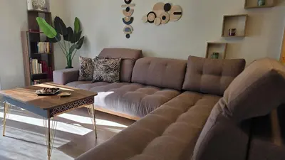 a living room with a couch and a coffee table at Glory Appartment pippinou in Athens