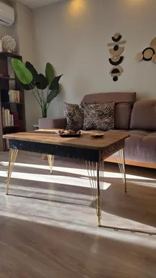 a coffee table in a living room with a couch at Glory Appartment pippinou in Athens