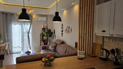 a living room with a couch and a table at Glory Appartment pippinou in Athens