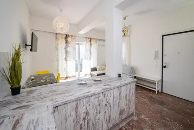 a living room with a large wooden counter in the middle at Chris Guesthouses in Anavissos