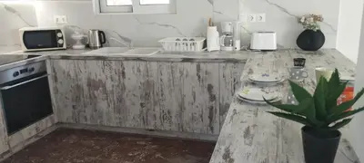 a kitchen with a wooden counter top with a sink at Chris Guesthouses in Anavissos