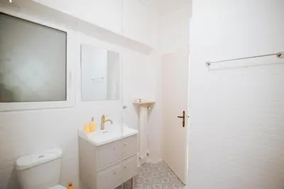 a white bathroom with a toilet and a sink at Urban Exarchia for Groups , Nightlife Area in Athens