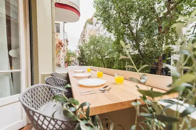 a table on a balcony with glasses of orange juice at Urban Exarchia for Groups , Nightlife Area in Athens