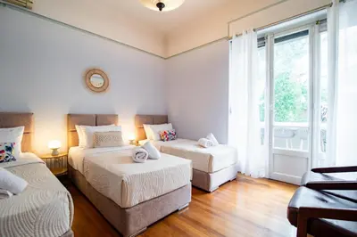 a bedroom with two beds and a window at Urban Exarchia for Groups , Nightlife Area in Athens