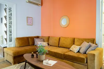a living room with a brown couch and a table at Urban Exarchia for Groups , Nightlife Area in Athens
