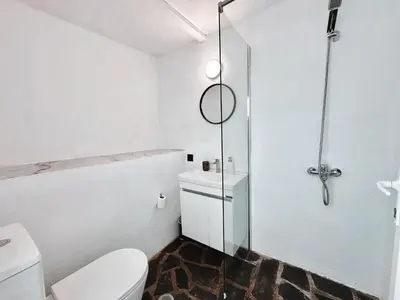 a white bathroom with a shower and a toilet at Elysian Sunrise Retreat with pool in Porto Rafti
