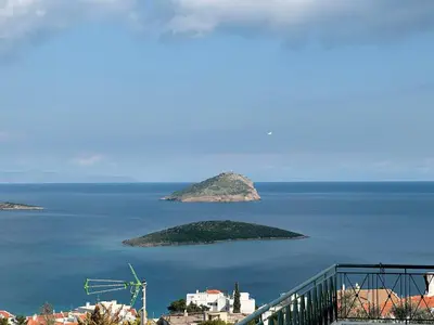 a view of an island in the middle of the ocean at Elysian Sunrise Retreat with pool in Porto Rafti