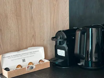 a coffee maker and a box of donuts on a counter at Elysian Sunrise Retreat with pool in Porto Rafti