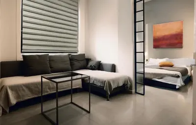 a living room with a couch and a bed at Luxsuite Premium with Panorama Rooftop in Athens