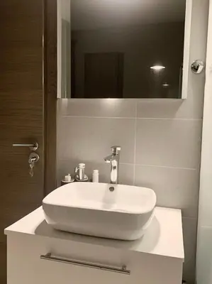 a white sink in a bathroom with a mirror at Luxsuite Premium with Panorama Rooftop in Athens