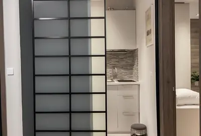 a room with a glass partition in a kitchen at Luxsuite Premium with Panorama Rooftop in Athens