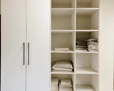 a white closet with white shelves at Luxsuite Premium with Panorama Rooftop in Athens