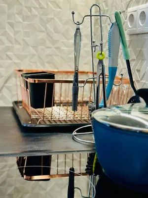 a drying rack with utensils on a kitchen counter at Modern Bohemian Suites - GVM in Athens