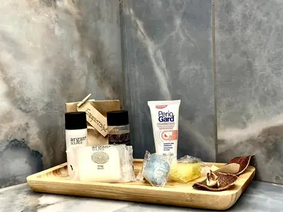 a wooden tray with products on a table at Modern Bohemian Suites - GVM in Athens