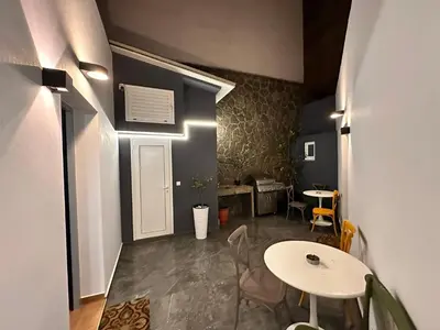 a room with a table and a table and chairs at Modern Bohemian Suites - GVM in Athens