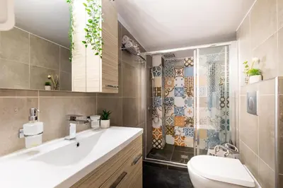a bathroom with a sink and a toilet and a shower at Acropolis Sights - Greecing in Athens