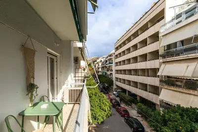 an apartment balcony with a view of a street at Acropolis Sights - Greecing in Athens
