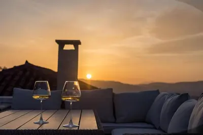 two wine glasses sitting on a table with a couch at Acropolis 360 Residence,2 bedr in Athens