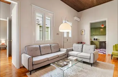 a living room with a couch and a table at Acropolis 360 Residence,2 bedr in Athens