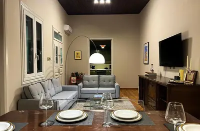 a living room with a table with wine glasses on it at Acropolis 360 Residence,2 bedr in Athens