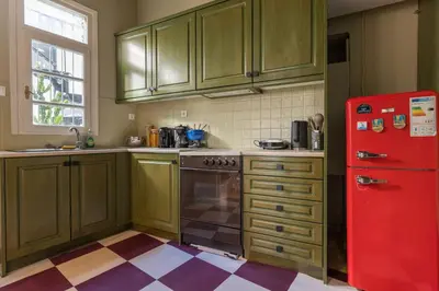 a kitchen with green cabinets and a red refrigerator at Acropolis 360 Residence,2 bedr in Athens