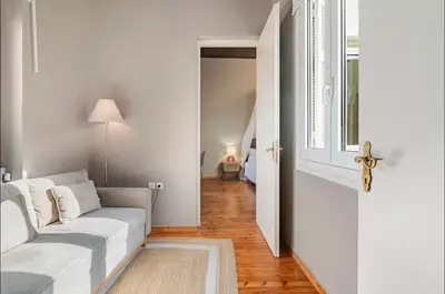 a living room with a white couch and a window at Acropolis 360 Residence,2 bedr in Athens
