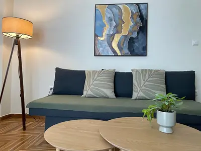 a living room with a couch and two tables at Koukaki lovely stay in Athens