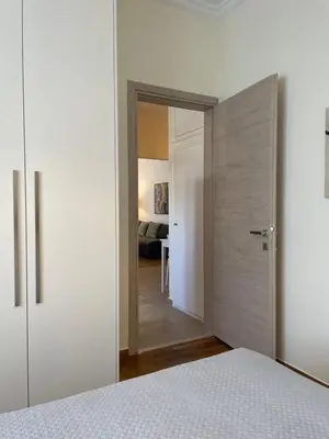 a bedroom with a bed and a door leading into a room at Koukaki lovely stay in Athens