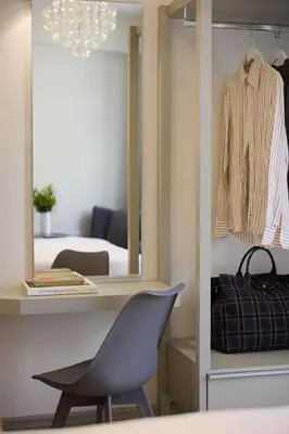 a desk with a chair and a mirror in a room at AthenSun Luxury Suites in Athens
