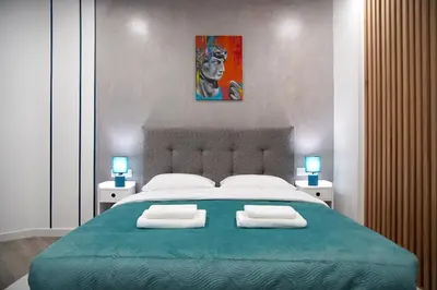 a bedroom with a large bed with two towels on it at Seaside Golden Horizon VIPGreece in Athens
