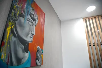 a painting of a woman hanging on a wall at Seaside Golden Horizon VIPGreece in Athens
