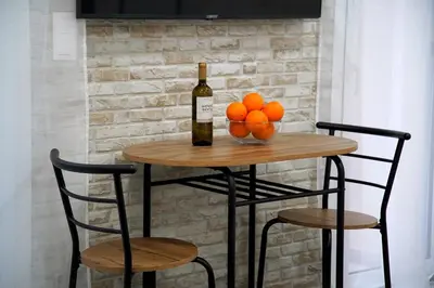 a table with a bottle of wine and oranges on it at Seaside Golden Horizon VIPGreece in Athens