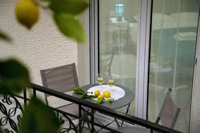 a table with two glasses of wine and fruit on it at Seaside Golden Horizon VIPGreece in Athens