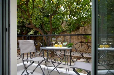 a table with two glasses of wine on a balcony at Seaside Golden Horizon VIPGreece in Athens